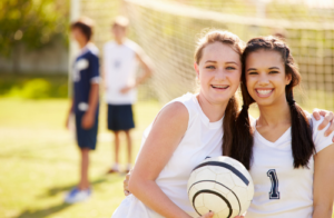 Girls Smiling playing Soccer