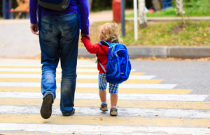 father with little daughter walking to school